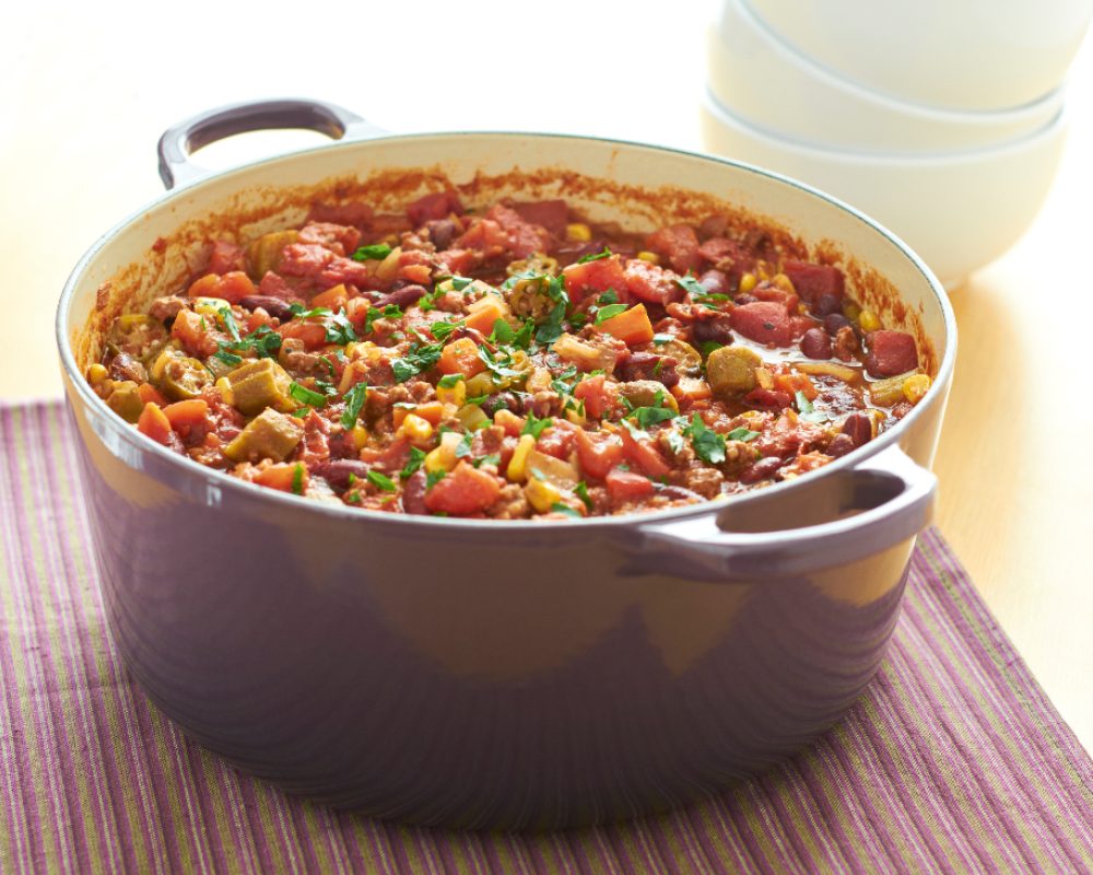 Cast iron casserole dish filled with a cooked one-pot meal